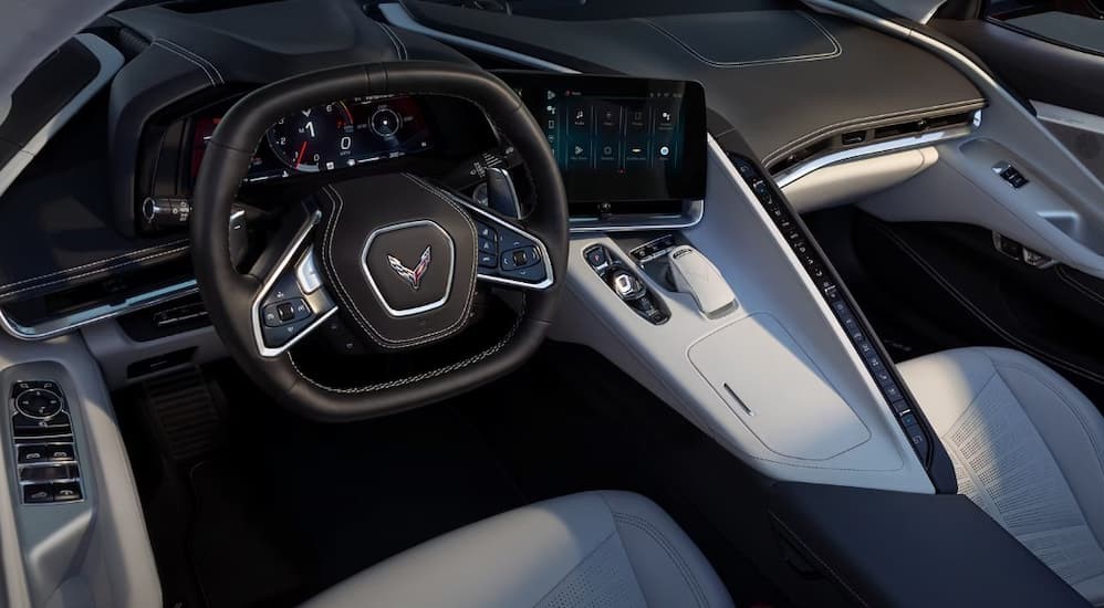 The black and white interior and dash are shown in a 2025 Chevy Corvette Stingray.