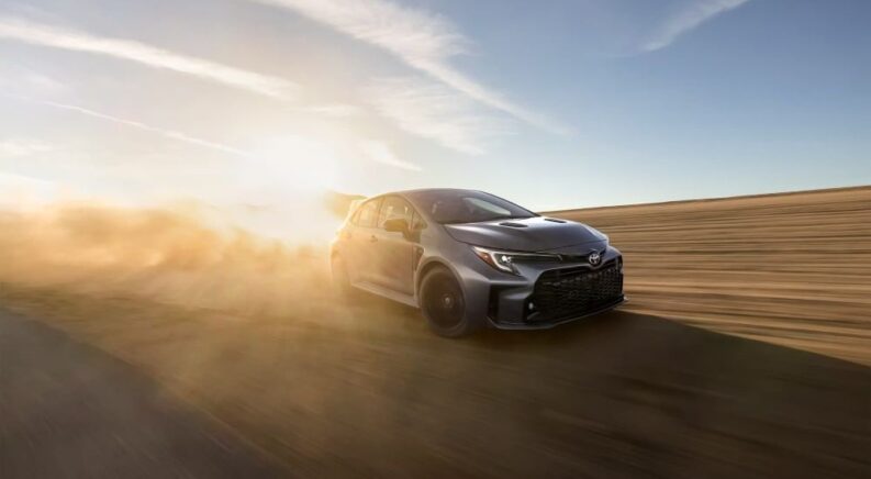 A gray 2023 Toyota GR Corolla Circuit Edition is shown driving on a sunny day.