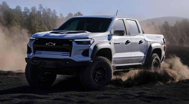 A white 2024 Chevy Colorado ZR2 Bison is shown off-roading.