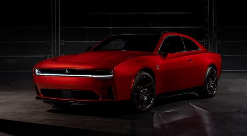 A red 2025 Dodge Charger Daytona Scat Pack is shown parked at a Dodge dealer near me.