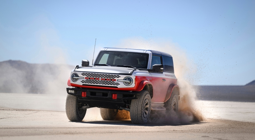 A red 2025 Ford Bronco Stroppe Edition is shown from the front at an angl after leaving a dealer that has a Ford Bronco for sale.