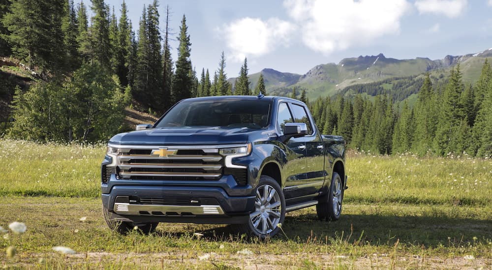 A blue 2025 Chevy Silverado 1500 High Country is shown from the front at an angle.