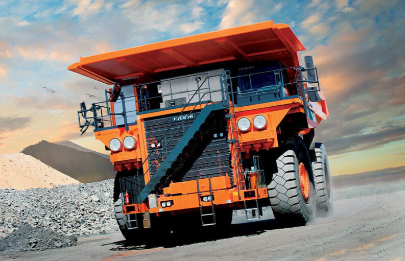 Front angle view of an orange Hitachi EH4000AC-3 Rigid Dump Truck driving off-road.