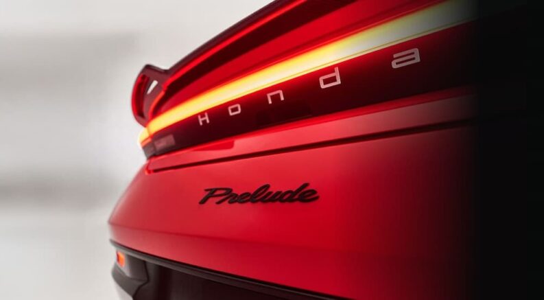 A close-up of the rear-end is shown on a red 2026 Honda Prelude.