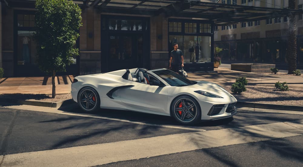 A white 2025 Chevy Corvette Stingray parked by a curb.