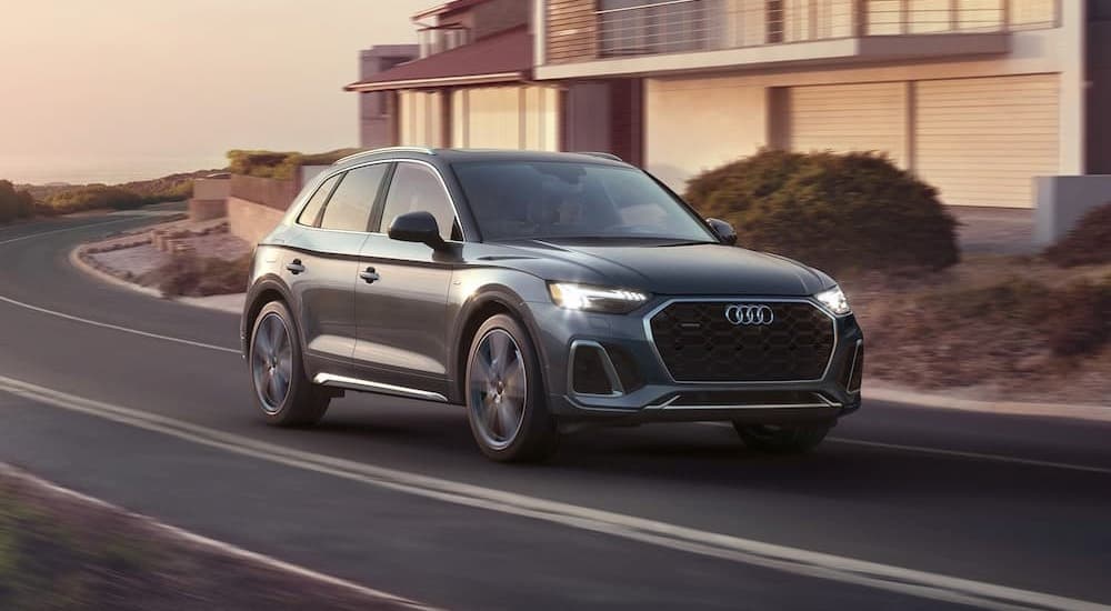 Gray 2023 Audi Q5 driving on a paved road
