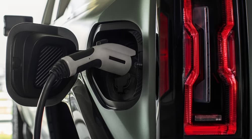 Green 2025 Hummer EV plugged into electric charger