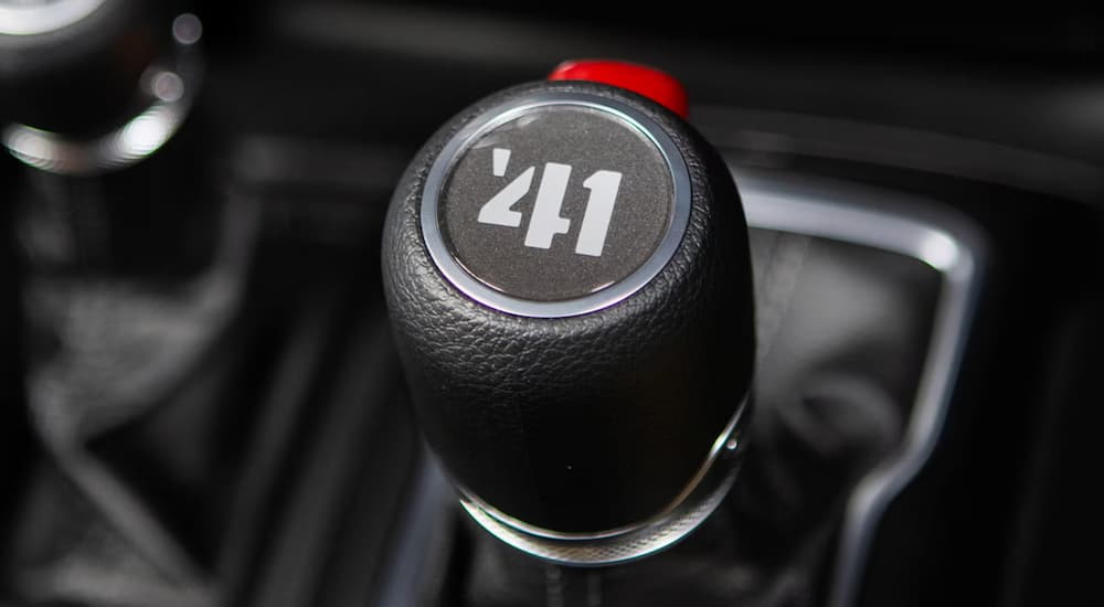 Close-up of a black car gear shift knob on a 2025 Jeep Wrangler for sale