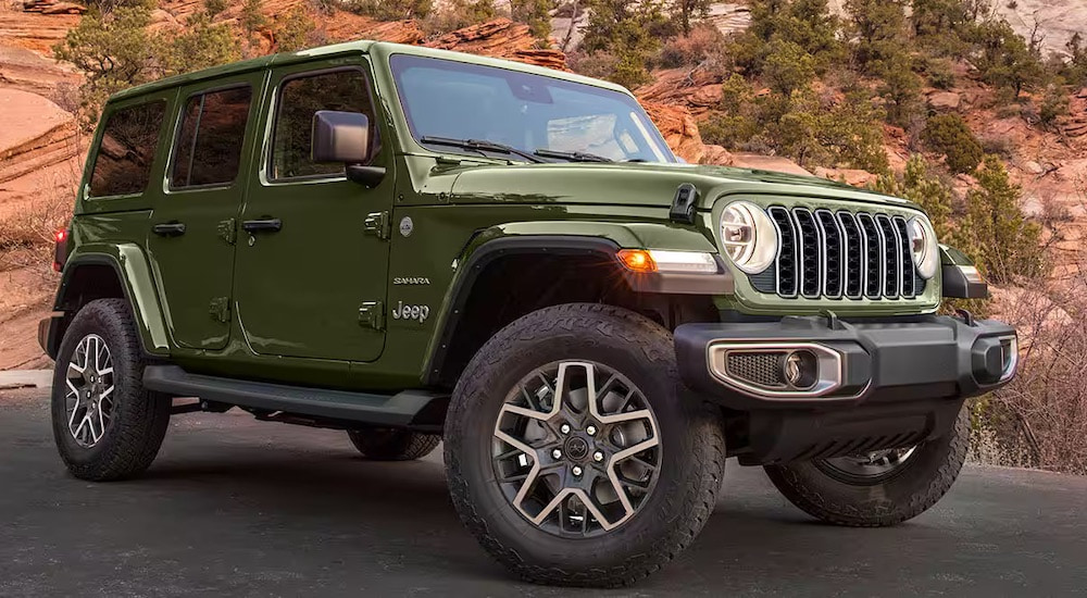 A green 2024 Jeep Wrangler from the front at an angle.