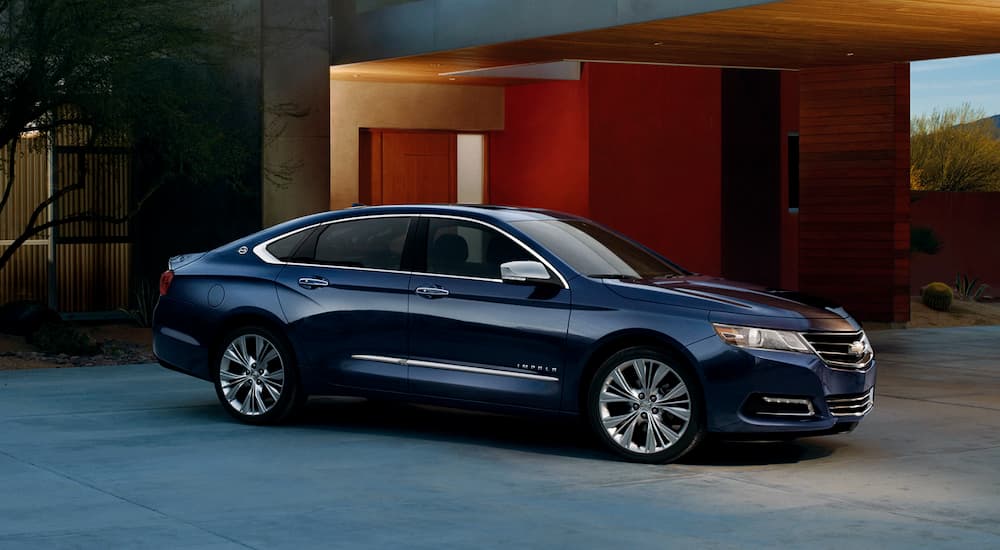 A black 2019 Chevy Impala parked in a driveway