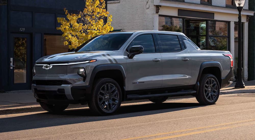 A silver 2025 Chevy Silverado EV parked in a city