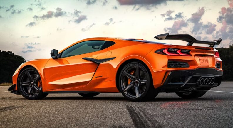 An orange 2025 Corvette Z06 parked on a race track