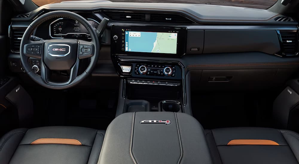 Infotainment and digital gauge cluster on a 2025 GMC Sierra 2500 AT4 at a dealer