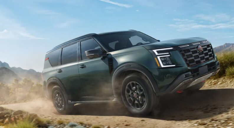 A green 2025 Nissan Armada driving off-road