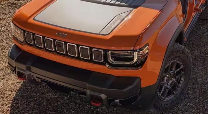 Close-up of the hood on an orange 2026 Jeep Recon EV for sale.