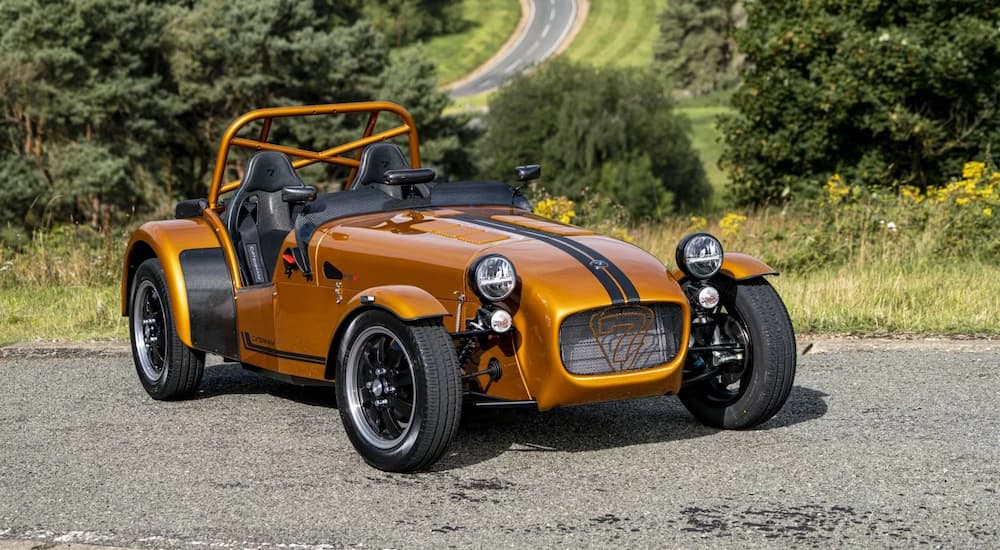 An orange Caterham 7 parked