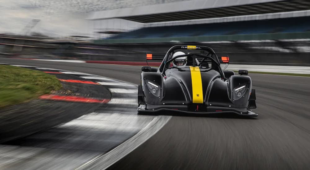 A black and yellow Radical SR3 on a race track