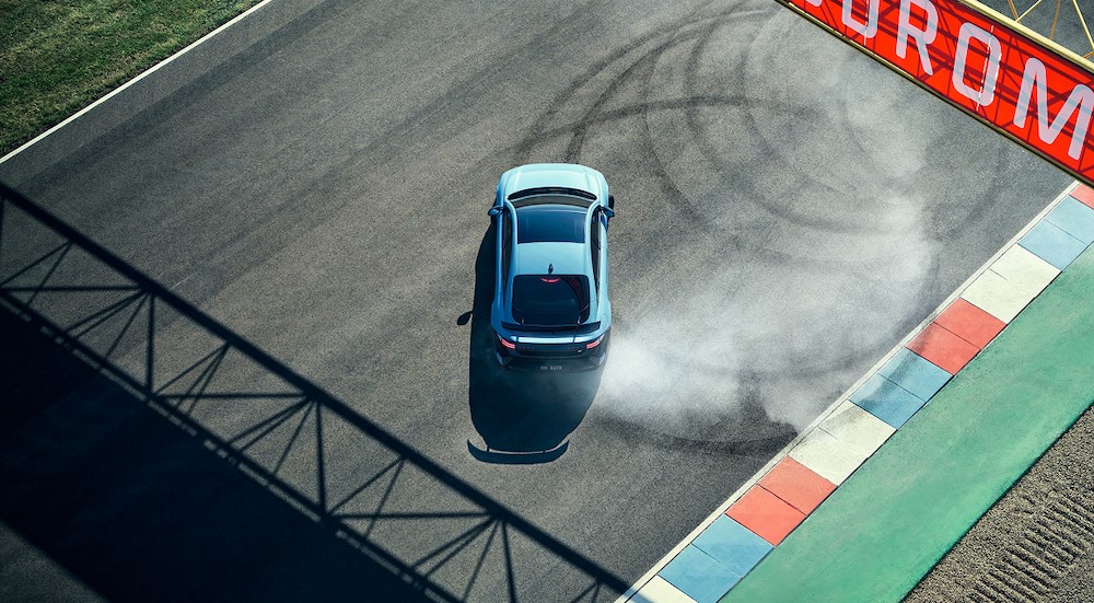 A blue 2026 Hyundai IONIQ 6 N doing donuts on a track.