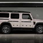 A white 2024 INEOS Grenadier 1924 for sale in a warehouse.