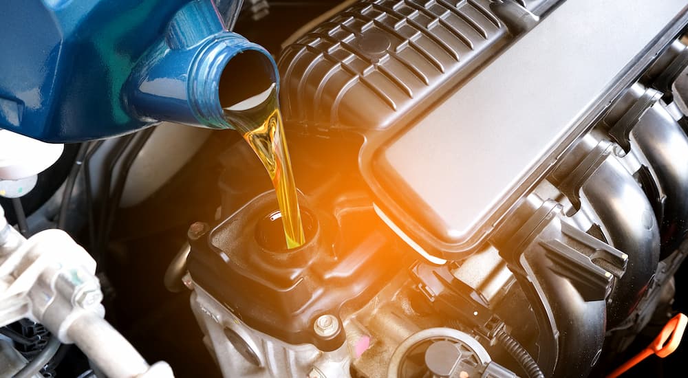 Technician adding oil during an oil change near Snellville