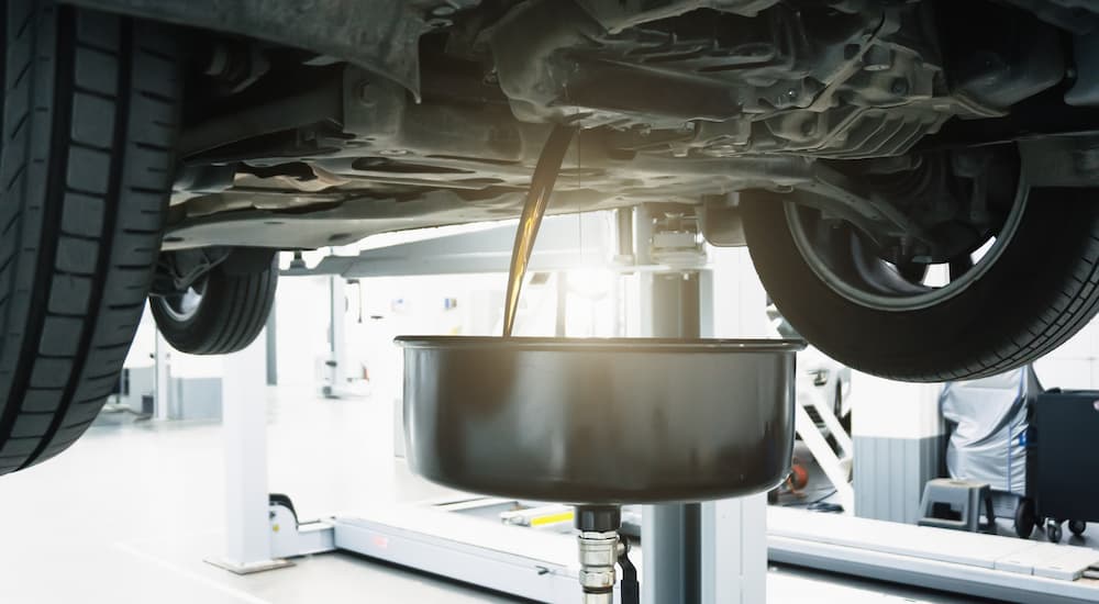 Oil going into an oil pan during a oil change service