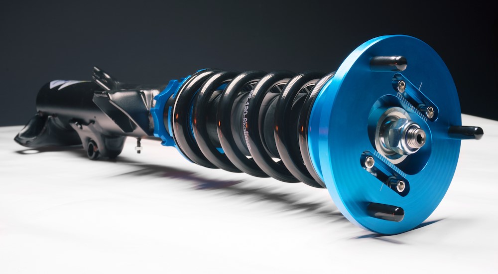 A black and blue coilover on a table.