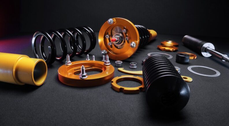 Coilover and suspension kit on a table.