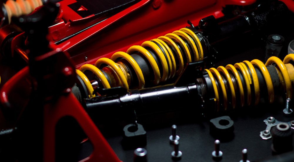 Suspension and coilover parts on a table.