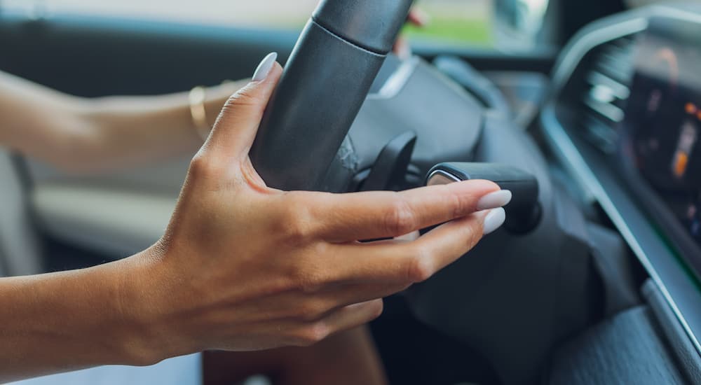 a woman using the paddle shifter on a car