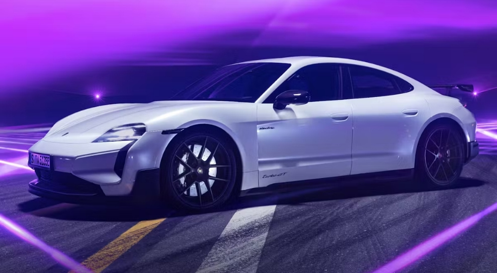 A white 2025 Porsche Taycan Turbo GT from the side.