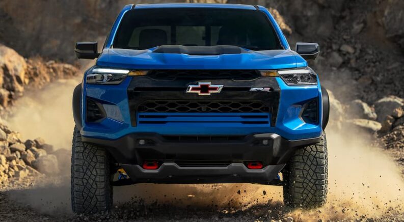 A blue 2025 Chevy Colorado ZR2 off-roading on a trail