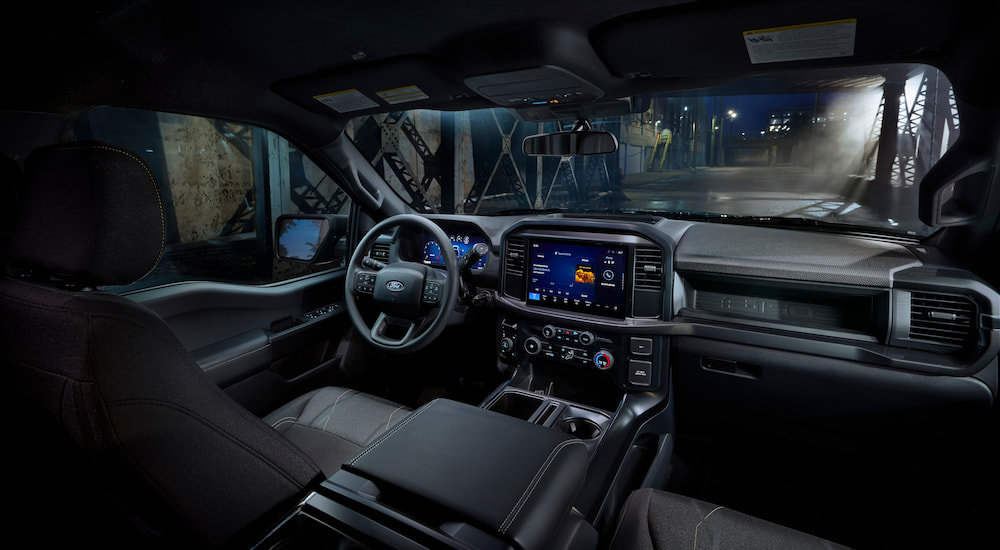 The steering wheel, dashboard and front seats inside a 2025 Ford F-150 Lobo.