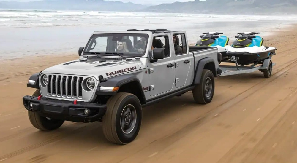Silver 2022 Jeep Gladiator Rubicon towing jetskis