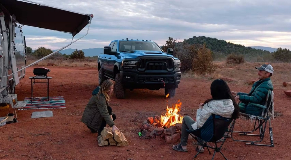 Blue 2023 Ram 1500 TRX at a campsite after looking at used trucks for sale