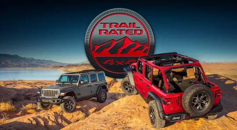 A Trail Rated badge above a gray and a red 2022 Jeep Wranglers.