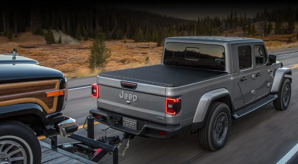 Silver 2022 Jeep Gladiator Wagoneer towing a vehicle