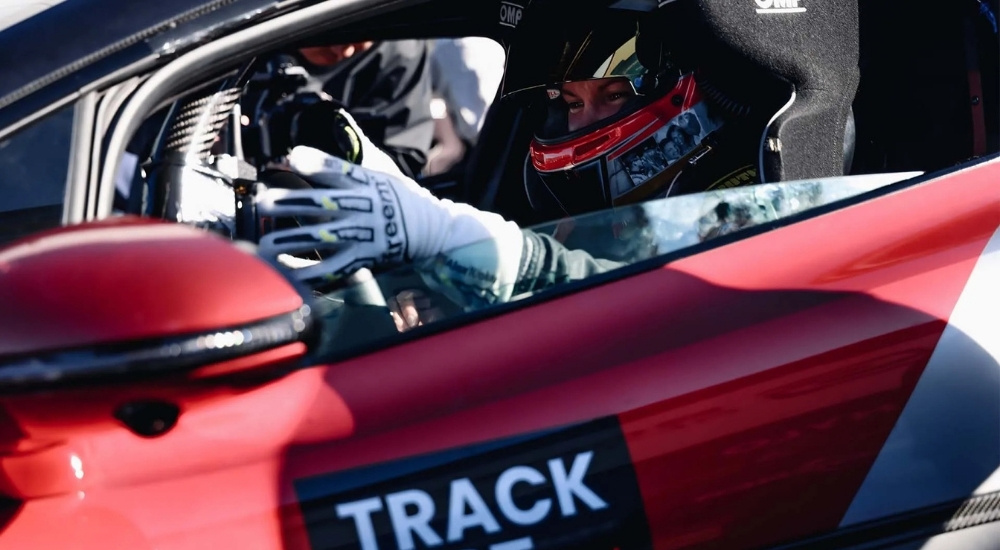 Racecar driver in a red YANGWANG U9 Xtreme