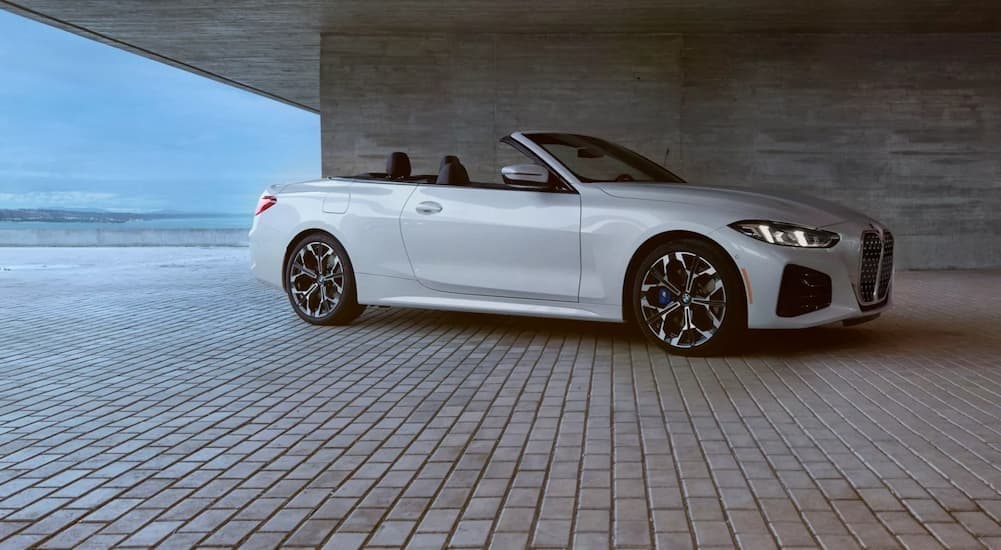 A white 2026 BMW 4 Series Convertible parked on a cloudy day.