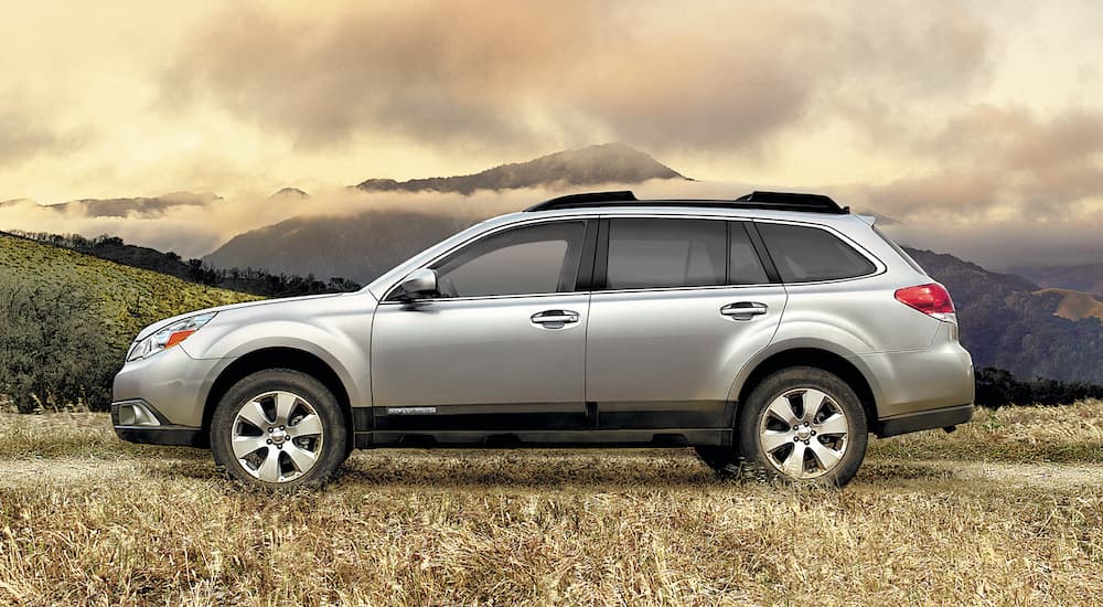 A silver 2008 Subaru Outback parked off-road