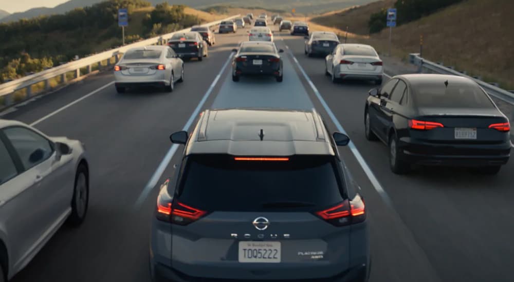 Grey 2021 Nissan Rogue Sport driving on a highway