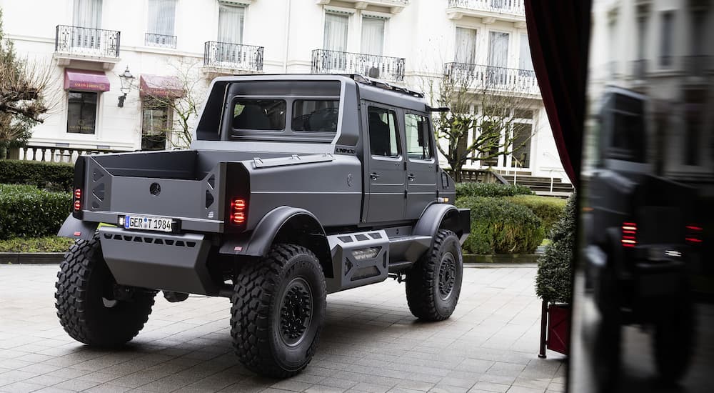 Rear view of a gray 2026 Mercedes-Benz Unimog parked outside a building
