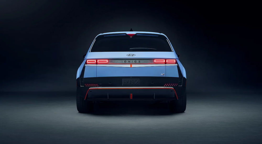 Blue 2025 Hyundai IONIQ 5 N rear view against gray backdrop