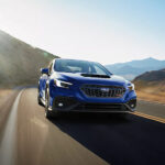 Blue 2026 Subaru WRX driving down road