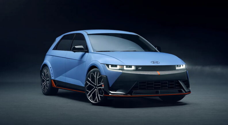 Blue 2025 Hyundai IONIQ 5 N idling against a gray backdrop.