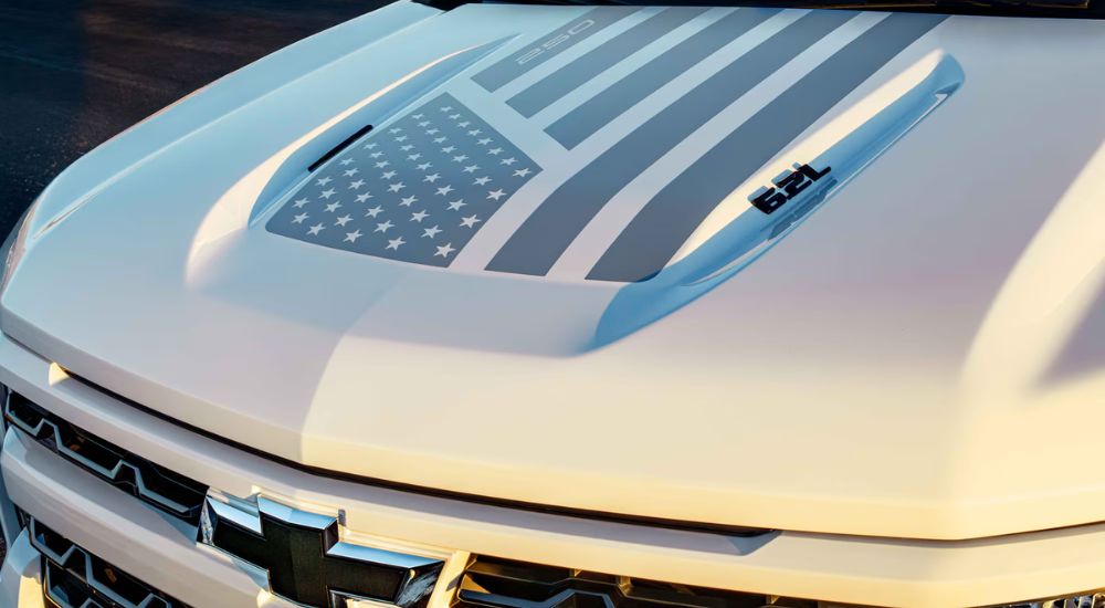 White 2026 Chevy Silverado Stars & Steel hood with flag decal.