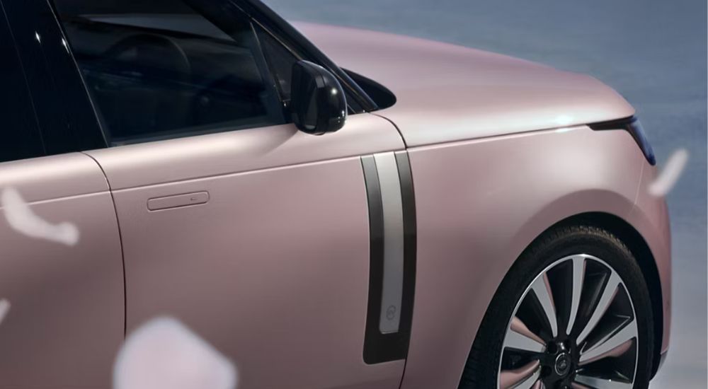A pink 2026 Range Rover SV shown zoomed in on passenger side.
