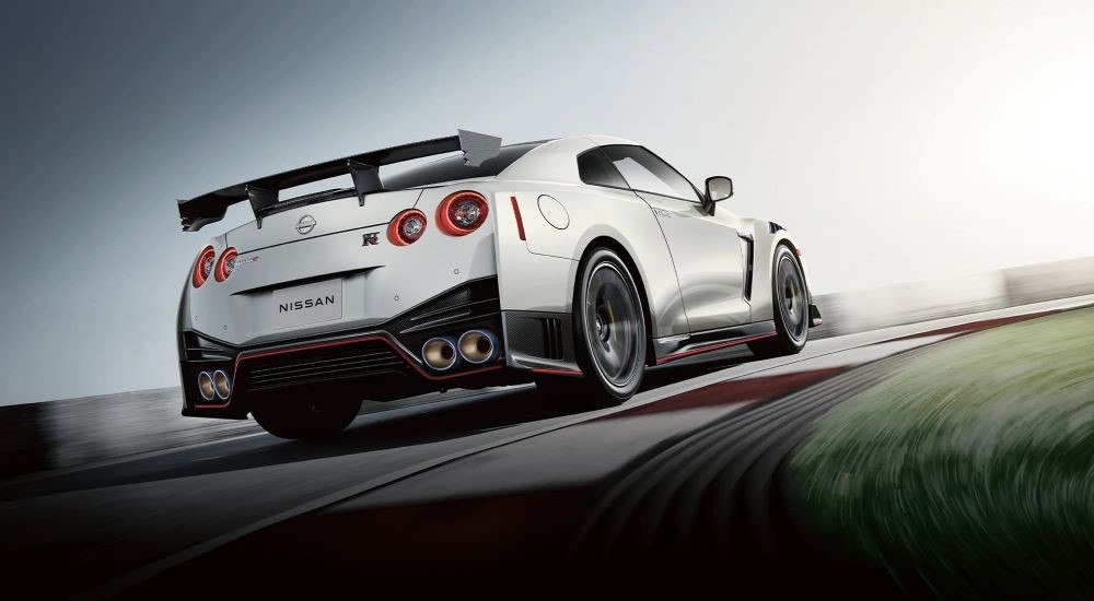 A white 2024 Nissan GT-R Nismo driving on a track