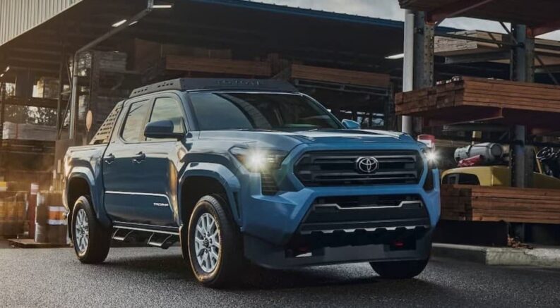 A blue 2026 Toyota Tacoma parked in a lumber yard.