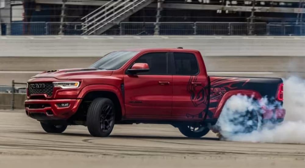A red 2027 Ram Rumble Bee performing a burnout.