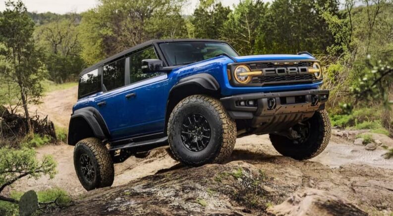 A blue 2025 Ford Bronco Raptor off-roading.